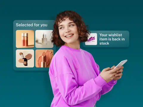 A smiling young woman in a pink sweatshirt holds a smartphone, with beauty products and a notification about a wishlist item in the background.